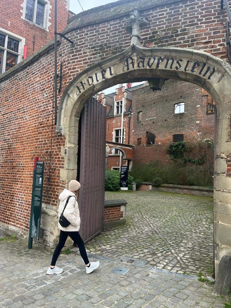 Girl strolling under an archway in Brussels