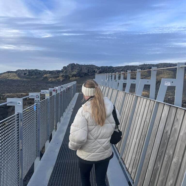 Blonde girl walks away from the camera across the Bridge Between Two Continents