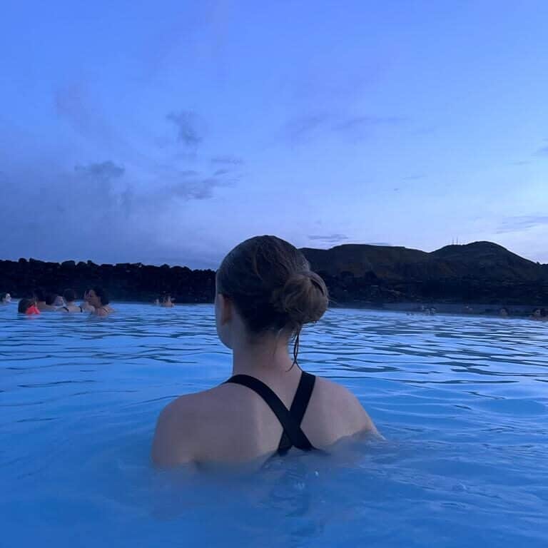 Girl faces away from the camera while relaxing in the Blue Lagoon