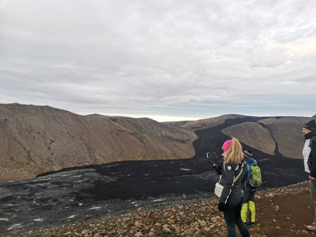 Tourists admire the recent lava flows at Fagradalsfjall