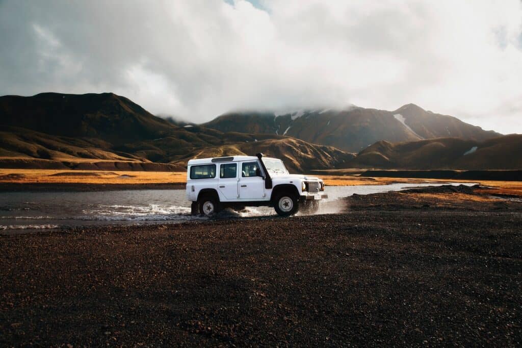 Jeep drives through volcanic landscape